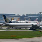 A New Zealand couple have demanded a refund after being seated next to a ‘farting’ dog on a long-haul Singapore Airlines flight.   (Photo by ROSLAN RAHMAN/AFP via Getty Images)