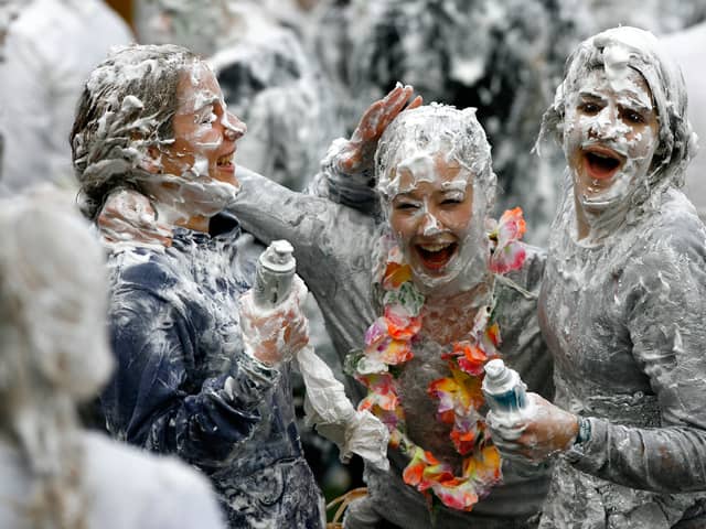 Students from St Andrews University indulge in a tradition of covering themselves with foam to honour the 'academic family' (Photo: Jeff J Mitchell/Getty Images)