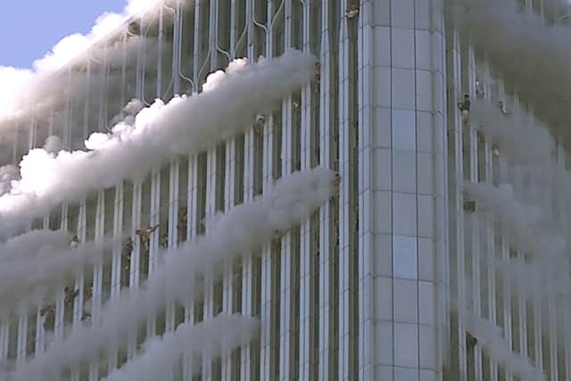 People hang from windows of World Trade Center after two hijacked passenger planes hit the building September 11, 2001 in New York City in an alleged terrorist attack. (Photo by Jose Jimenez/Primera Hora/Getty Images)
