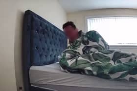 The man in Caitlin's bed on August 29, 2023. A mum watched in horror as a security camera caught an intruder breaking into her home - and falling asleep on her bed. (SWNS)