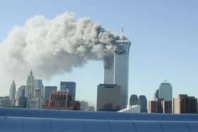 Smoke pours from the World Trade Center after being hit by two planes September 11, 2001 in New York City. (Photo by Fabina Sbina/ Hugh Zareasky/Getty Images)