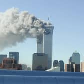 Smoke pours from the World Trade Center after being hit by two planes September 11, 2001 in New York City. (Photo by Fabina Sbina/ Hugh Zareasky/Getty Images)
