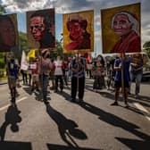 Climate activists hold up portraits of slain Philippine environmental defenders in 2021 (Photo by Ezra Acayan/Getty Images)