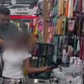 The video shows the woman being detained by the male shopkeeper (Photo: Screengrab)