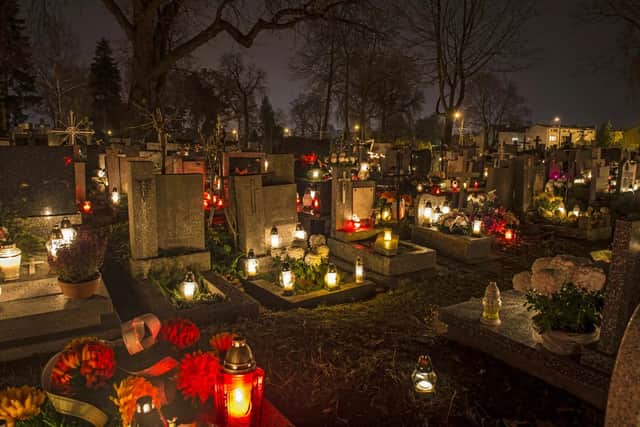 Candle lit in a cemetery to commemorate All Saints Day (Credit: Jaroslaw Grudzinski/Fotolia)