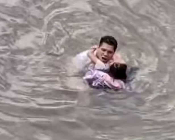 Heroic bystander jumped into a fast-flowing river to rescue a young girl in China