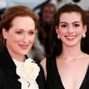 Actresses Meryl Streep (L) and Anne Hathaway were the stars of the Devil Wears Prada film. They are pictured at the premiere in 2006. The story has now been turned into a musical. Photo by Getty Images.