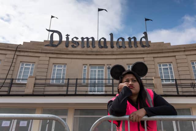 A steward is seen outside Banksy's 'Dismaland' exhibition,  in Weston-Super-Mare, England.(Photo by Matthew Horwood/Getty Images)