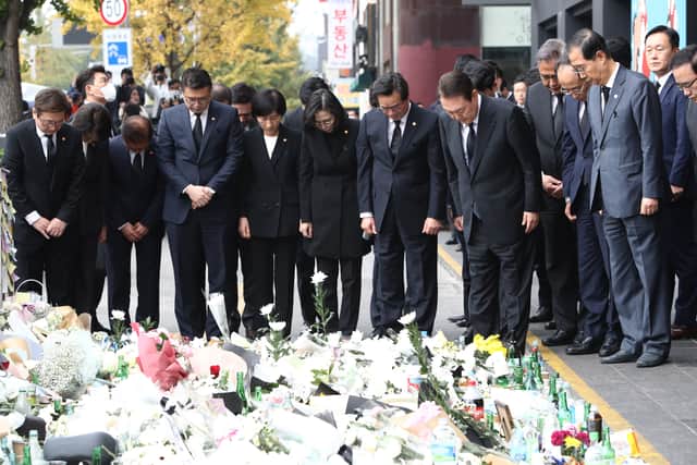 South Korean President Yoon Suk-yeol and cabinet members pay tribute to the victims of the Halloween celebration stampede, on the street near the scene on November 01, 2022 in Seoul, South Korea. (Photo by Chung Sung-Jun/Getty Images)