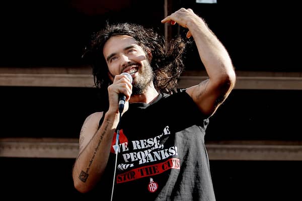 LONDON, ENGLAND - JUNE 21:  Comedian Russell Brand speaks to a crowd of thousands of demonstrators that gathered in Parliament Square, on June 21, 2014 in London, England. The crowd marched from Oxford Circus to Parliament Square to voice their opposition to government austerity cuts. (Photo by Mary Turner/Getty Images)