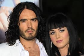 Actor Russell Brand and his then partner singer Katy Perry pose on the red carpet as they arrive for the premiere of the comedy movie "Get Him to the Greek" from Universal Pictures at the Greek Theatre in Los Angeles on May 25, 2010.                AFP PHOTO/Mark RALSTON (Photo credit should read MARK RALSTON/AFP via Getty Images)