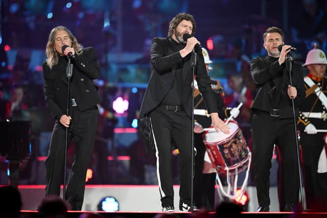 Take That (L-R) Mark Owen, Howard Donald and Gary Barlow perform inside Windsor Castle grounds at the Coronation Concert, in Windsor, west of London on May 7, 2023. (Photo by LEON NEAL/POOL/AFP via Getty Images)