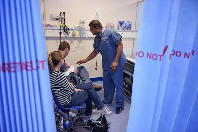 A doctor attends to a young patient in the specialist Children’s Accident and Emergency department of the ‘Royal Albert Edward Infirmary’ in Wigan, north west England on April 2, 2015. Credit: AFP via Getty Images