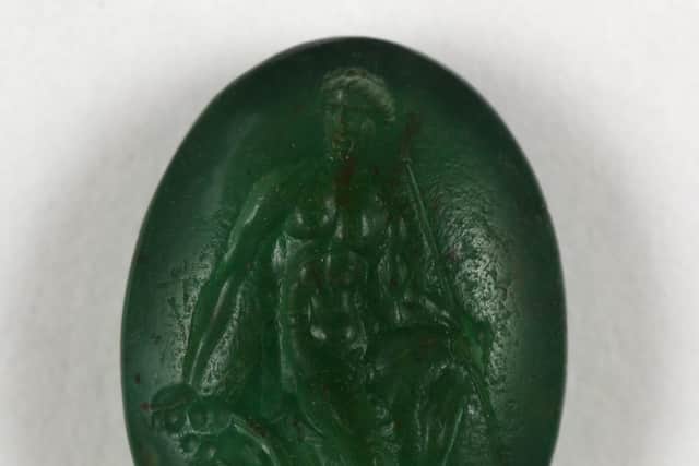 Undated handout photo issued by the British Museum of the upper part of a sard gem engraved with Sarapis wearing a calatho, 1st-3rd century AD, similar to the items missing from their collections. 