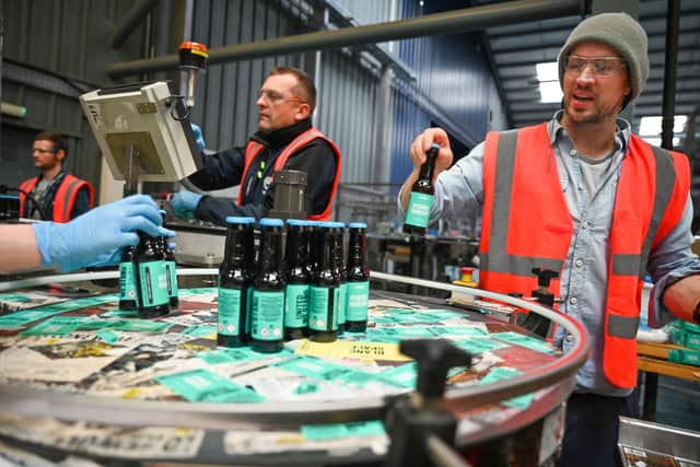 ELLON, SCOTLAND - APRIL 03: BrewDog founder  James Watt packs hand sanitizer being produced at the plant  on April 03, 2020 in Ellon, Scotland. Scotland based brewery BrewDog have adapted their production to develop and produce hand sanitizer to donate to various charities across the UK as well as the NHS working throughout the Coronavirus (COVID-19) pandemic. The Coronavirus (COVID-19) has spread to many countries across the world, claiming over 50,000 lives and infecting over 1 million people. (Photo by Jeff J Mitchell/Getty Images)