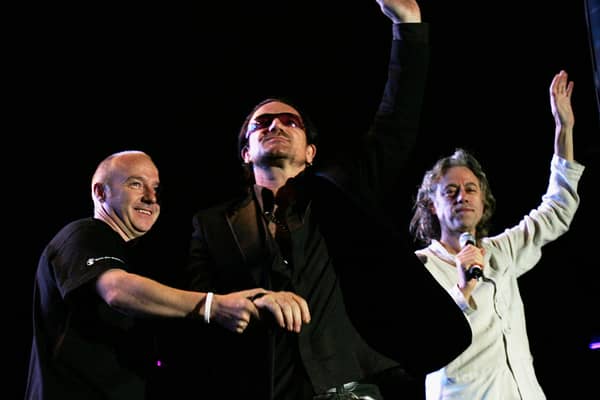 EDINBURGH, SCOTLAND - JULY 6:  Midge Ure, Bono and Bob Geldof are seen at the Live 8 Edinburgh concert at Murrayfield Stadium on July 6, 2005 in Edinburgh, Scotland. The free gig, labelled Edinburgh 50,000 - The Final Push, is organised by Midge Ure, alongside Geldof, and coincides with the G8 summit to raisie awareness for MAKEpovertyHISTORY. (Photo by Scott Barbour/Getty Images) 