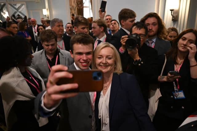 Ex-PM Liz Truss snaps a selfie with a Tory member. Credit: Getty