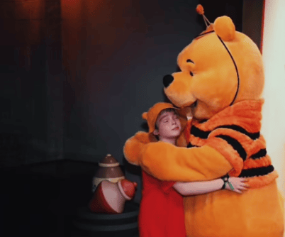 Drew Patchin, aged 10, who has a rare kind of brain tumour called ependymoma, is pictured on a trip to Disney World with Winnie the Pooh. Photo by TikTok.