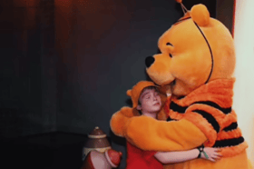 Drew Patchin, aged 10, who has a rare kind of brain tumour called ependymoma, is pictured on a trip to Disney World with Winnie the Pooh. Photo by TikTok.
