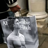 A shopper leaves the Abercrombie & Fitch UK Flagship Store on Savile Row in London, England (Photo by Gareth Cattermole/Getty Images)