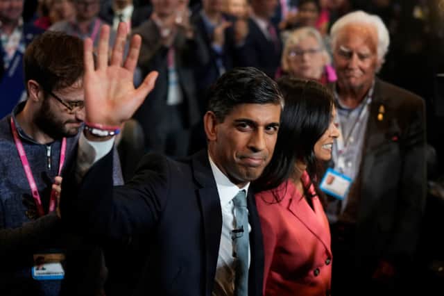 Rishi Sunak leaves the Conservative Party Conference with his wife Akshata Murthy, who introduced him on stage. Credit: Getty