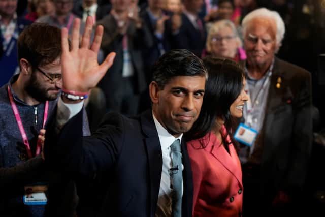 Prime Minister Rishi Sunak waves as he and wife Akshata Murty leave following his speech during the final day of the Conservative Party Conference, during which he announced the scrapping of the Manchester leg of the HS2 rail link (Photo: Christopher Furlong/Getty Images)