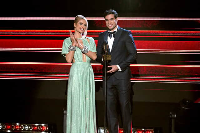 CORAL GABLES, FLORIDA - OCTOBER 05: Paris Hilton and Danilo Carrera speak onstage during the 2023 Billboard Latin Music Awards at Watsco Center on October 05, 2023 in Coral Gables, Florida. (Photo by Jason Koerner/Getty Images)