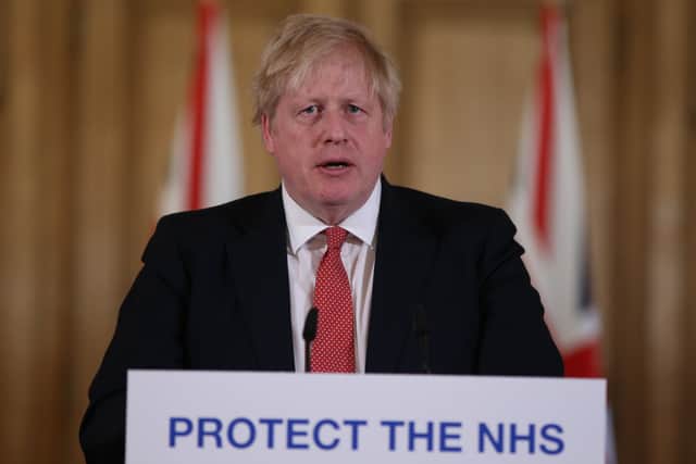 British Prime Minister Boris Johnson gives his daily Covid-19 press briefing at Downing Street on March 22, 2020 (Photo by Ian Vogler-WPA Pool/Getty Images)