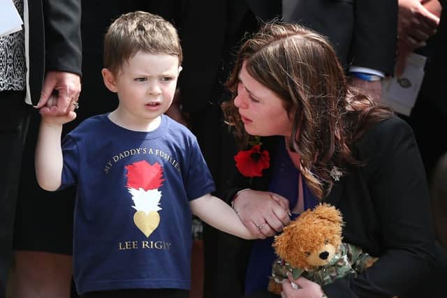 Two-year-old Jack Rigby is comforted by his mother Rebecca as the coffin of his father Fusilier Lee Rigby leaves Bury Parish Church after a military funeral on July 12, 2013 in Bury, Greater Manchester, England (Peter Macdiarmid/Getty Images)