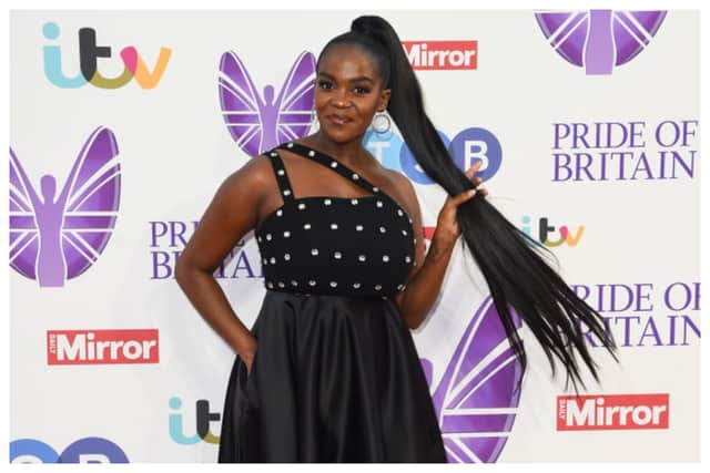 Oti Mabuse looked chic in a black asymmetrical dress with silver studs. Photograph by Getty

