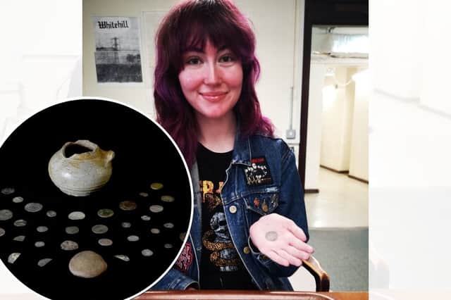 Archaeology student Lucy Ankers, looking at a coin hoard she discovered hidden under a fireplace during an archaeological dig (PA Wire)