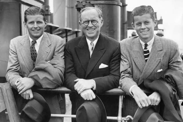John Fitzgerald Kennedy (R, 1917-63) and his brother Joseph Patrick Kennedy Jr  (L,1915-44), surround their father Joseph on July 2, 1938 in Southampton on the deck of French "Normandy" cruiser liner after their arrival from the US. 09 November 1960,  (Photo by -/FRANCE PRESSE VOIR/AFP via Getty Images)