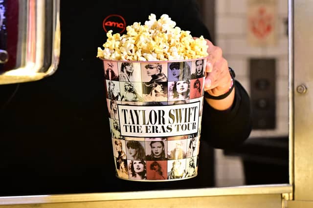 TOPSHOT - A tub of popcorn in US singer Taylor Swift's merchandise is pictured during the "Taylor Swift: The Eras Tour" concert movie world premiere at AMC Century City theatre in Century City, California on October 12, 2023. (Photo by Frederic J. BROWN / AFP) (Photo by FREDERIC J. BROWN/AFP via Getty Images)