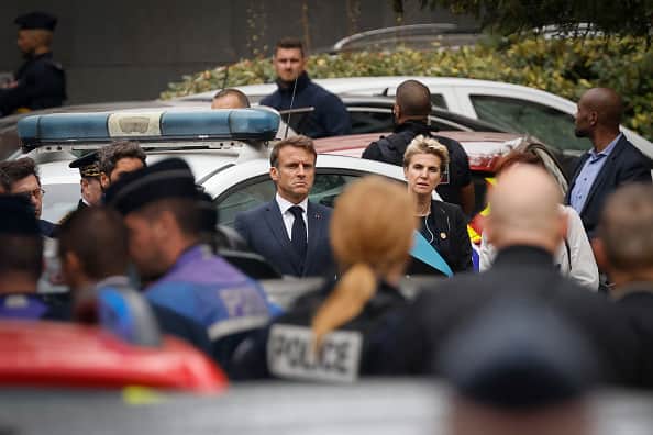 French President Emmanuel Macron (C) arrives at the Gambetta high school in Arras, northeastern France on October 13, 2023, after a teacher was killed and two other people severely wounded in a knife attack.