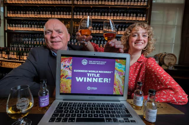Master Ambassador John McCheyne, and Madeleine Schmoll Social Media and Community Manager raise a toast as the whisky club set the Guinness World Record for largest online tasting event to mark their 40th anniversary.