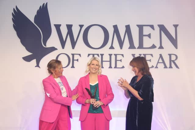 Lisa Woodcock receives her award alongside Mel Giedroyc and Lorraine Kelly. Credit: Dave Benett