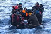 Asylum seekers wearing life jackets sit in a dinghy as they cross the English Channel from France to Britain on 15 March, 2022. Credit: Sameer Al-DOUMY / AFP via Getty Images