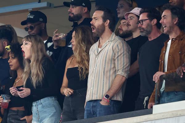 OCTOBER 01: (L-R) Singer Taylor Swift, Actor Ryan Reynolds and Actor Hugh Jackman cheer prior to the game between the Kansas City Chiefs and the New York Jets at MetLife Stadium on October 01, 2023 in East Rutherford, New Jersey. (Photo by Elsa/Getty Images)