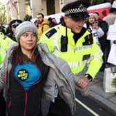 Swedish climate activist Greta Thunberg is arrested by police outside the Intercontinental London Park Lane during the "Oily Money Out" demonstration (Photo by HENRY NICHOLLS/AFP via Getty Images)