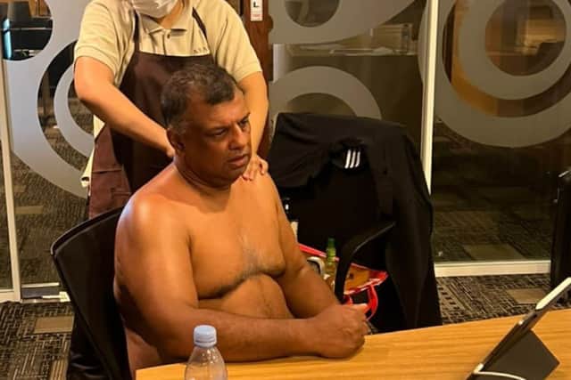 Tony Fernandes posted the image of himself getting a massage on LinkedIn - and then deleted it several days later.  Credit: Tony Fernandes/LinkedIn