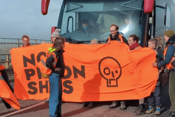 Just Stop Oil protesters block a coach they say was crying refugees to controversial Bibby Stockholm Barge in Dorset on Thursday (October 19).