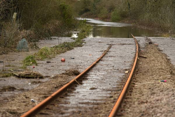 Silt and flood water covers railway train tracks in 2020 after Storm Jorge (Photo: OLI SCARFF/AFP via Getty Images)