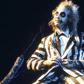 Michael Keaton and the iconic striped suit will be a part of the 2024 sequel to 'Beetlejuice' (Credit: Warner Bros. Pictures)