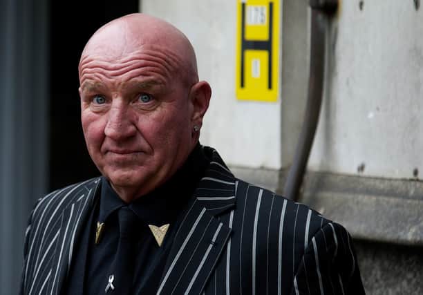 Ex-Gangster turned author Dave Courtney looks on as he arrives to attend the funeral of the mastermind of the 1963 Great Train Robbery,  Bruce Reynolds at Priory Church of Saint Bartholomew the Great in central London, on March 20, 2013. (47 million euros, $63 million).  AFP PHOTO / ANDREW COWIE)
