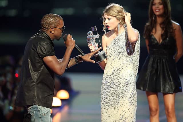 Kanye West (L) jumps onstage after Taylor Swift (C) won the "Best Female Video" award during the 2009 MTV Video Music Awards at Radio City Music Hall on September 13, 2009 in New York City. (Photo by Christopher Polk/Getty Images)