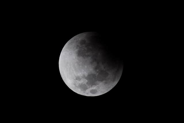 The moon is seen during a partial lunar eclipse in Caracas, on November 19, 2021. (Image: FEDERICO PARRA/AFP via Getty Images)