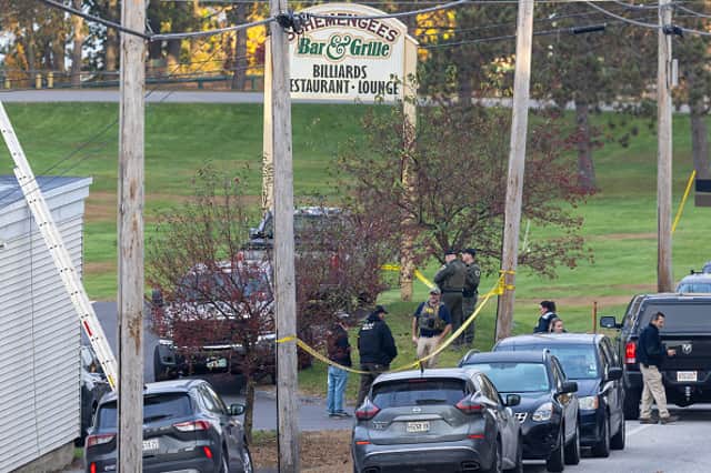 LEWISTON, MAINE - OCTOBER 26: Law enforcement officials investigate outside the Schemengees Bar and Grille on October 26, 2023 in Lewiston, Maine. Police are still searching for the suspect in the mass shooting, Robert Card, who killed over 15 people in two separate shootings. (Photo by Scott Eisen/Getty Images)