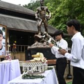 Members of the Thai "Wild Boars" youth football team line up to pay respects to their late teammate Duangphet "Dom" Phromthep (Image: LILLIAN SUWANRUMPHA/AFP via Getty Images)