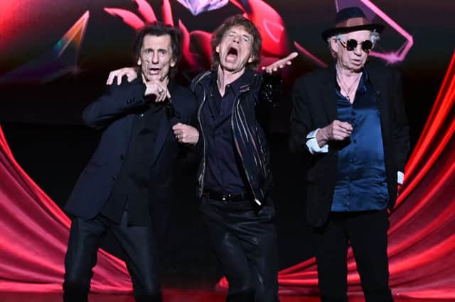 (L-R) Ron Wood, Mick Jagger and Keith Richards of legendary British rock band, The Rolling Stones pose on stage during a launch event for their new album, "Hackney Diamonds" at Hackney Empire in London on September 6, 2023, their first album of original material since 2005. (AFP via Getty Images)