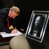 Sir Kenny Dalglish signs the book of condolence for Sir Bobby Charlton at Old Trafford. (Picture: Liverpool FC)